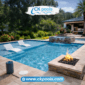 Modern backyard pool renovation featuring a sunshelf, water feature, fire pit, and updated stone decking